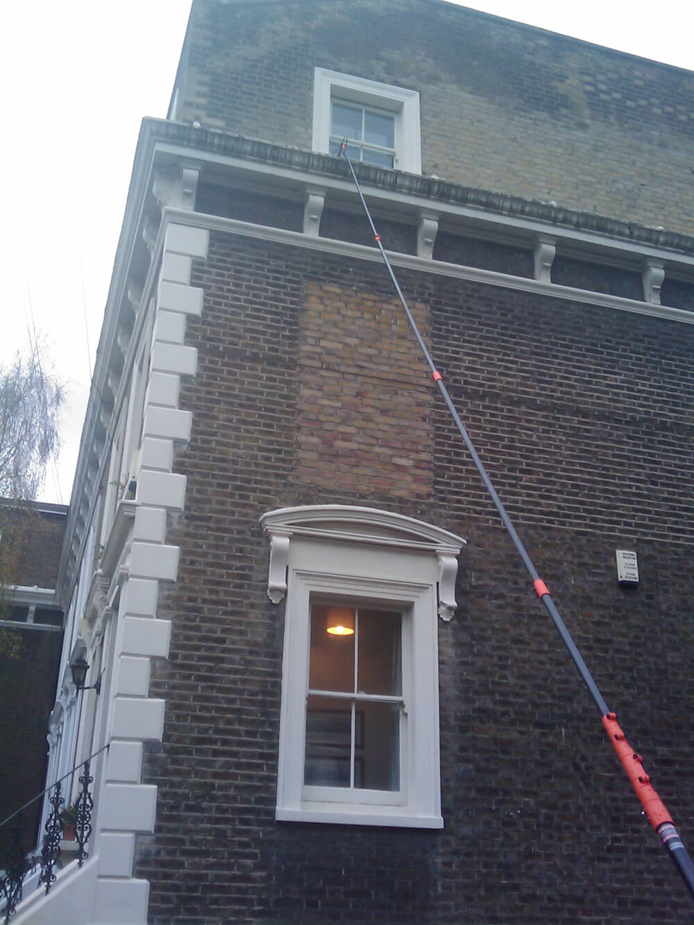 Safe window cleaning via water-fed poles by Anyclean